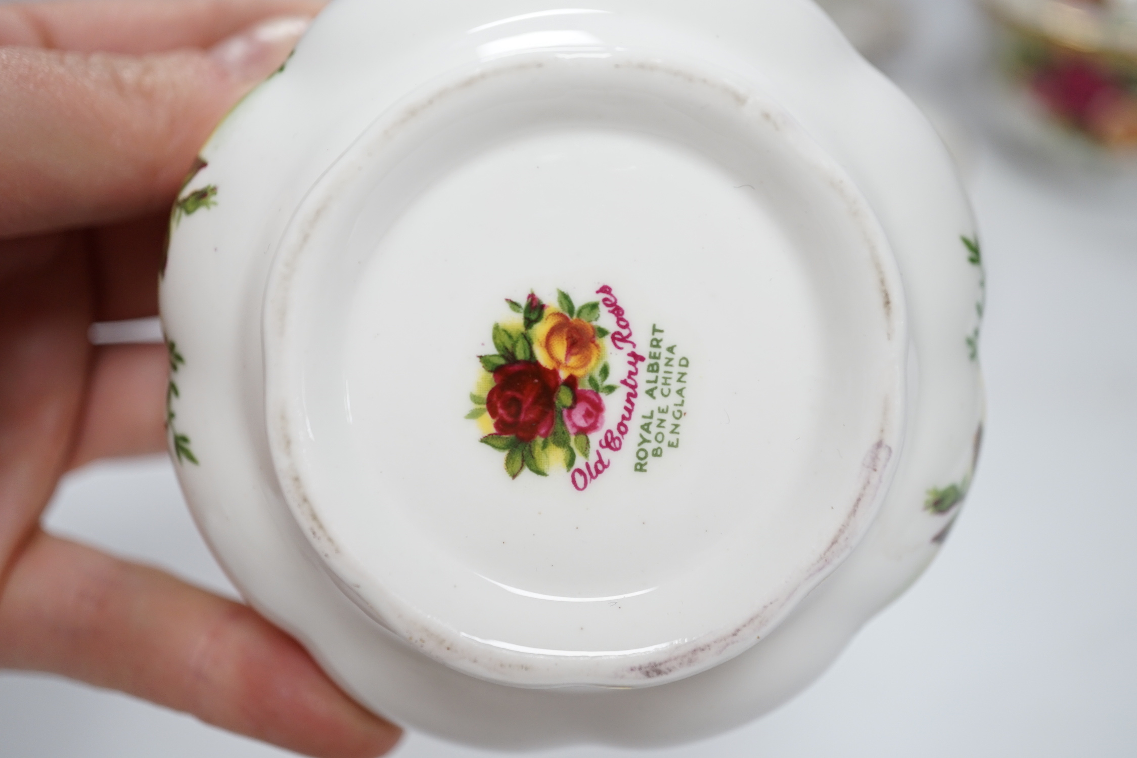 A quantity of Royal Albert old country roses pattern teawares including teapot, various cups and saucers, side plates, cake stand, coffee, pot, quartz, clock, sugar bowl, trays, etc.
